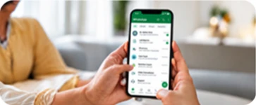 Hands holding a phone showing the CareMonk patient chat
